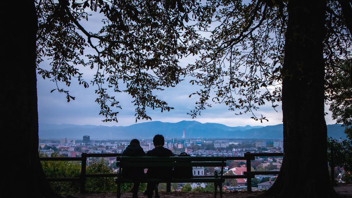 A view over Ljubljana at dusk from the wooded hill above the city